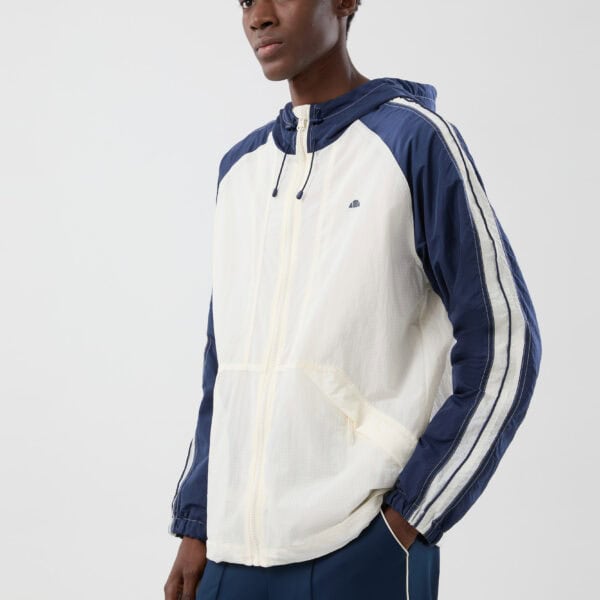 Modische Ellesse Jacke in Ecru mit blauen Akzenten, sportlich und bequem für den Alltag.