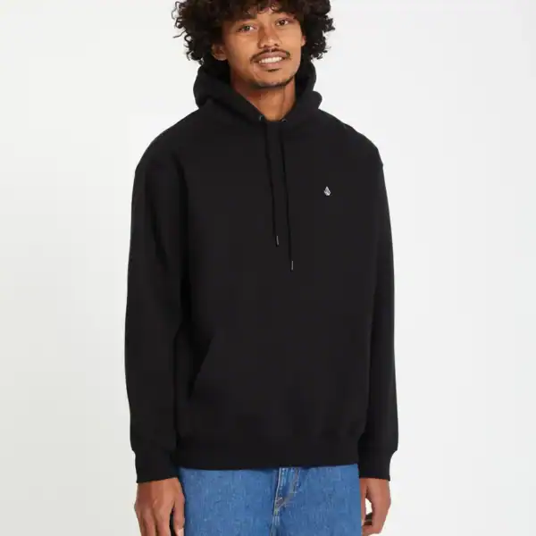 Mann trägt schwarzen Kapuzenpullover von Volcom mit Logo-Details, lässiger Style, auf weißem Hintergrund.